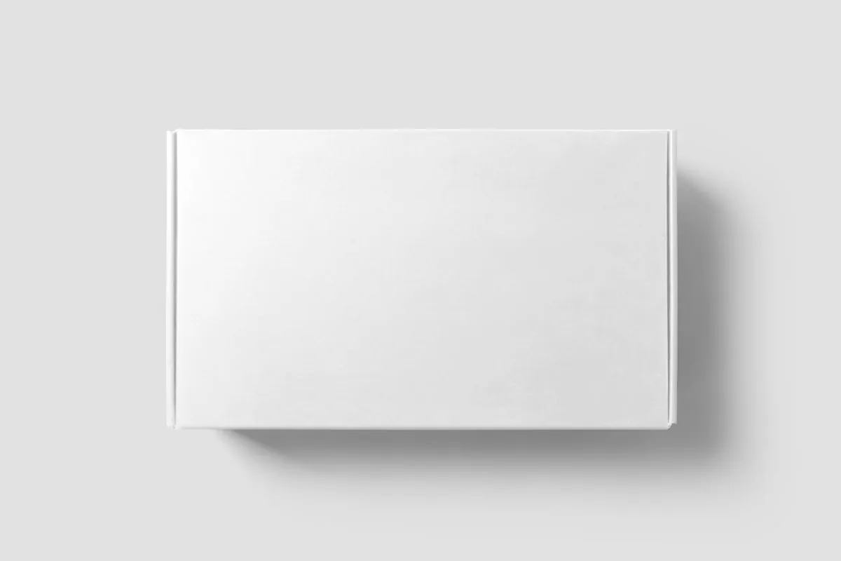 A plain white corrugated mailer box photographed from above